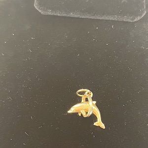 Yellow gold dolphin pendant/charm.